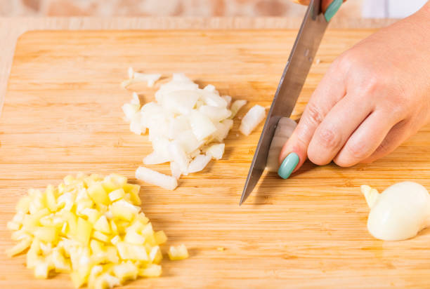 istock Cook cuts onions with a knife 820335174