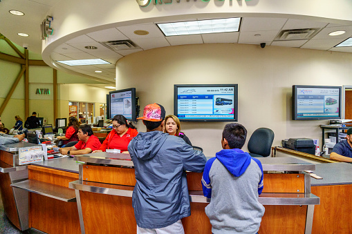 McAllen, USA - January 05, 2017: McAllen downtown area bus station waiting room. People buying tickets at counter