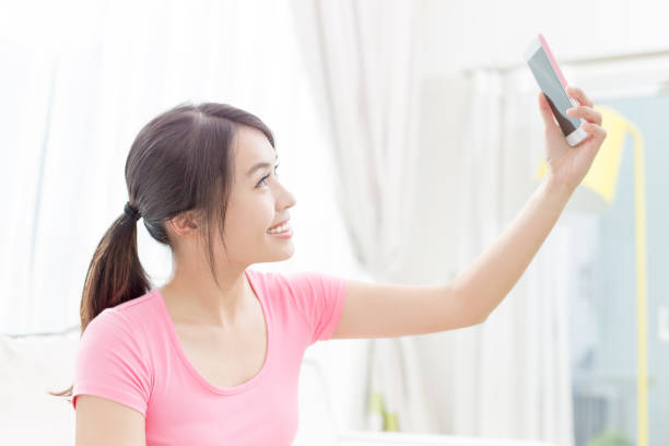 istock woman selfie happily 820343106
