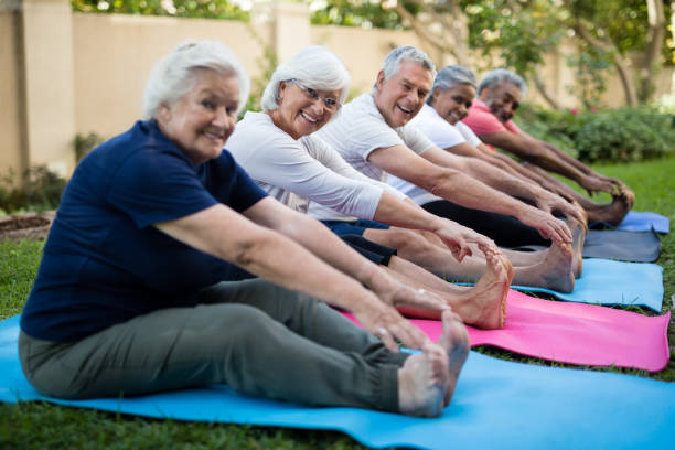 istock Happy senior people doing stretching exercises at park 820347426
