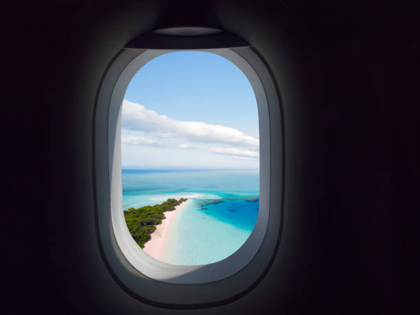 airplane window with paradisaical beach and sea view - airplane porthole imagens e fotografias de stock