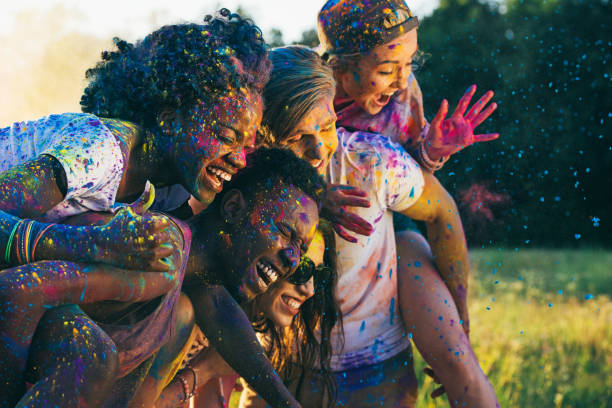 multicultural happy friends piggybacking together at holi festival multicultural happy friends piggybacking together at holi festival the black womens expo stock pictures, royalty-free photos & images