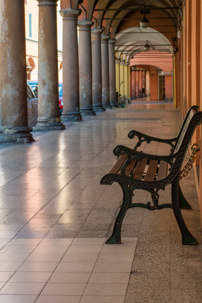 istock Brown wooden bench in the orange gallery with columns 820370462