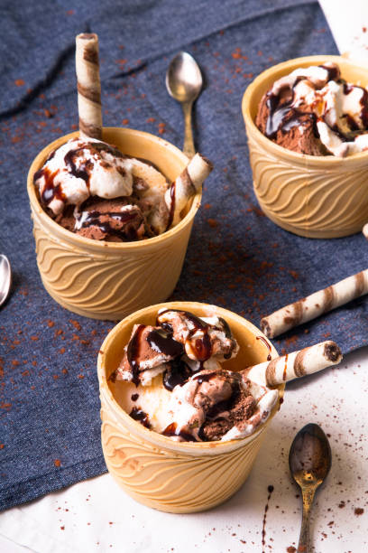 istock Delicious ice cream in a cup with chocolate sauce and cream rolls 820371472