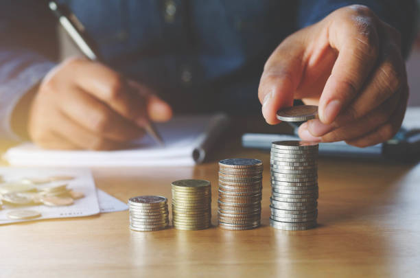 istock business accounting with saving money with hand putting coins on stack concept financial 820371592