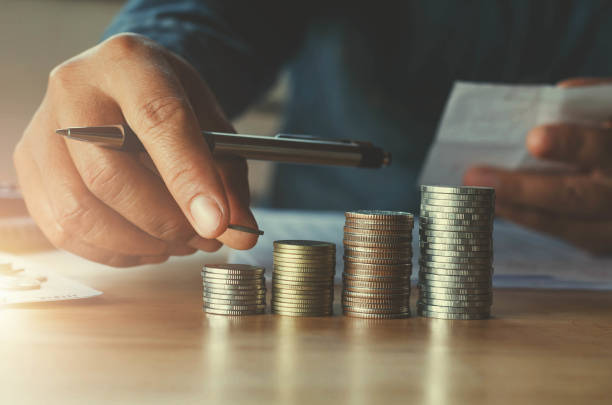 istock business accounting with saving money with hand putting coins on stack concept financial 820374478