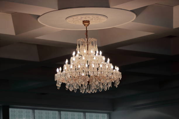 istock Luxury crystal chandelier hanging under ceiling in the room. 820375856