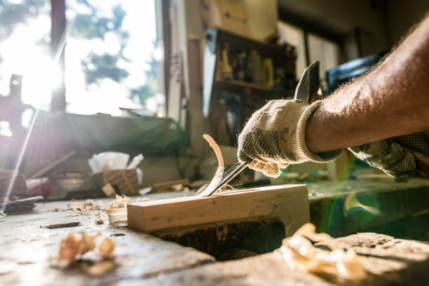istock An experienced carpenter shapes wood with a chisel 820379118