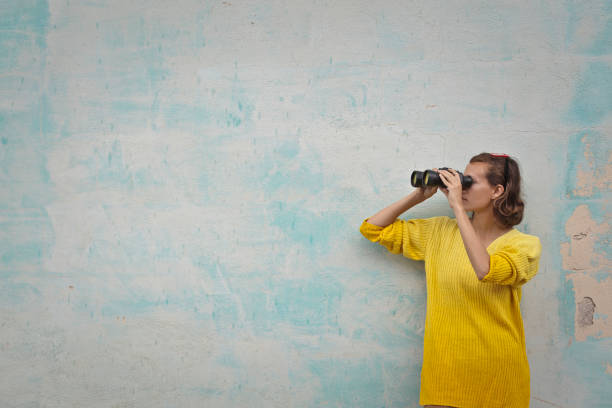 binoculars woman with binoculars on green background searching binoculars stock pictures, royalty-free photos & images