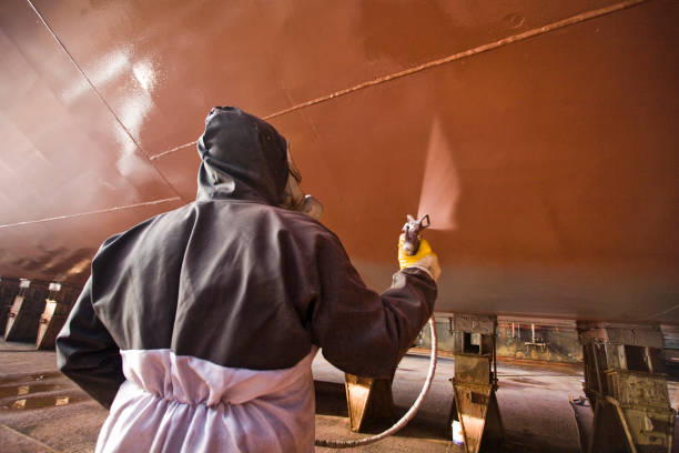 Ship painter Ship painting in shipyard with spray passenger ship stock pictures, royalty-free photos & images