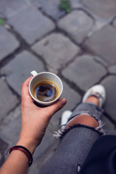 istock Young woman's hand holding cup of espresso 820384790