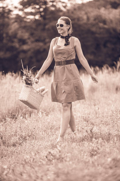 istock Young Woman Walking in the Summer Meadow 820390330