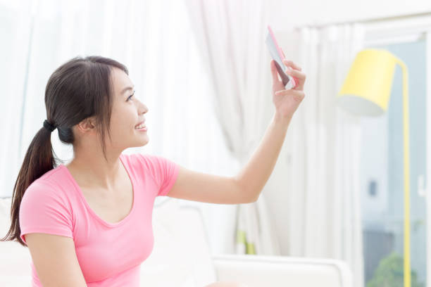 istock woman selfie happily 820390696