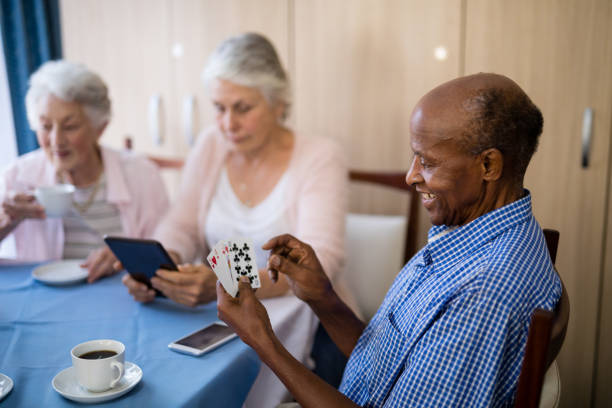 istock Senior man playing cards with friends while having coffee 820392124