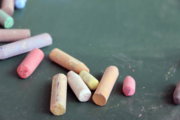 istock Colorful used chalks on green school board 820399290