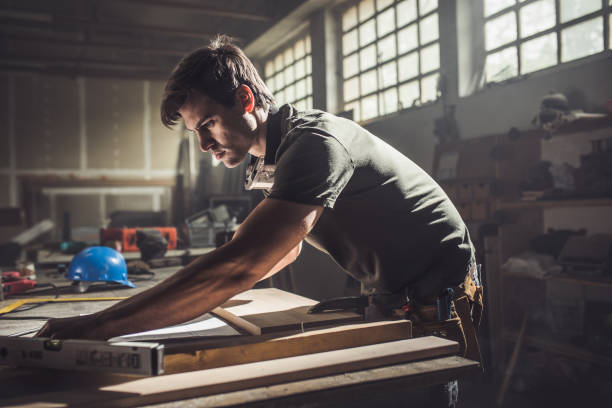 istock Hard-working carpenter working on a new design in a factory. 820416236