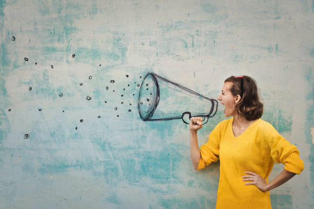 Strong messages Young woman holding an imaginary megaphone and shouting into it communication stock pictures, royalty-free photos & images