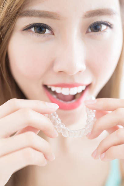 istock woman take invisible braces 820438110