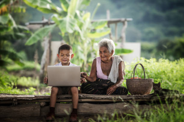 Happy boy and grandmother using laptop, Education.