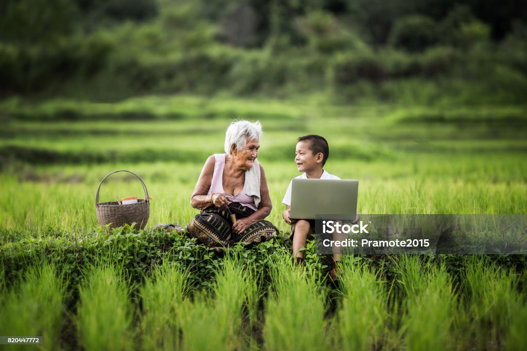 Happy boy and grandmother using laptop, asia thailand. Thailand Stock Photo