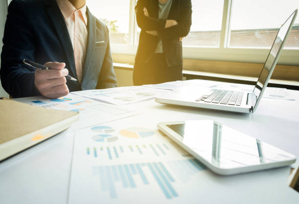 istock Business team two colleagues discussing new plan financial graph data on office table with laptop and digital tablet 820449398
