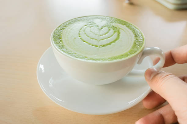 istock a man's hand holding a hot matcha green tea cup 820449480