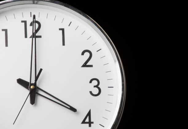 Analog clock with the time 4 o'clock stock photo