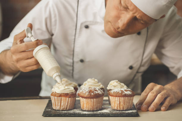 Bakery chef cooking bake in the kitchen professional put cream