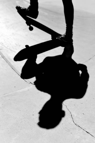 istock young man skateboarding, in black and white 820471574