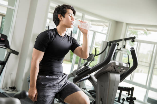 istock Asian men are drinking clean water While cycling exercise at the gym. 820475984
