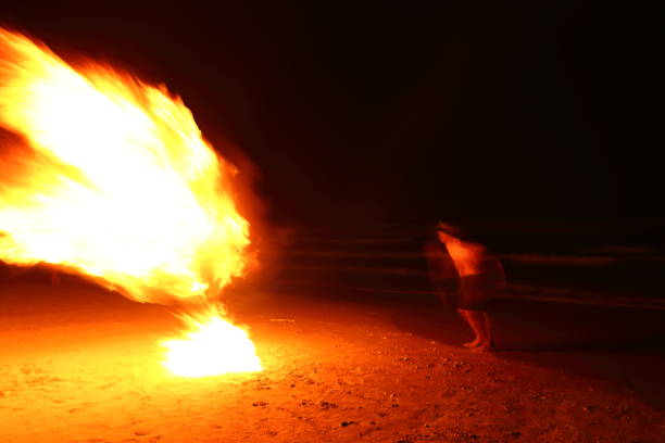 istock Skill Man playing fireworks by spinning wood pole with fuel oil and fire 820476444