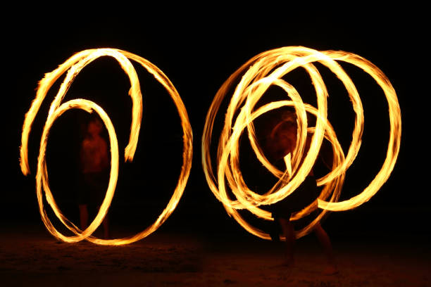 istock Skill Man playing fireworks by spinning wood pole with fuel oil and fire 820476670