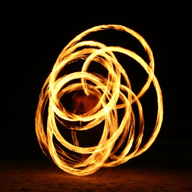 istock Skill Man playing fireworks by spinning wood pole with fuel oil and fire 820476720
