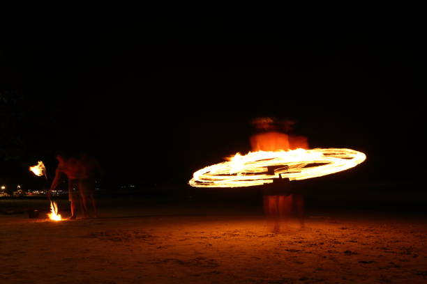 istock Skill Man playing fireworks by spinning wood pole with fuel oil and fire 820476816