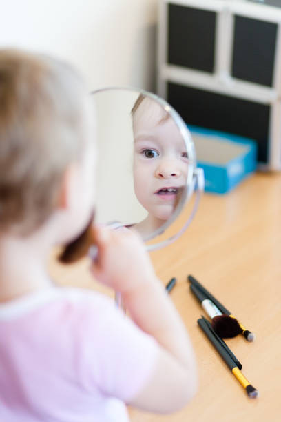istock 2 years old girl child is doing makeup 820477032