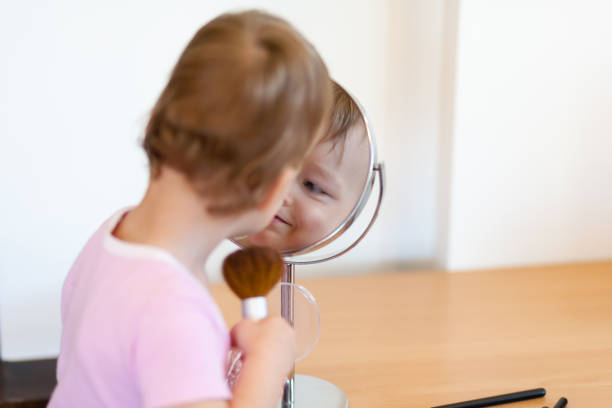 istock 2 years old girl child is doing makeup 820477062