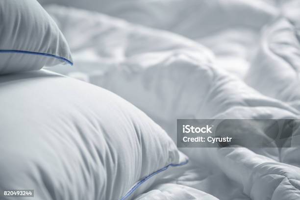 White Pillows And Blanket Wrinkle Messy Blanket In Bedroom After Waking Up In The Morning Bed Details Duvet And Blanket An Unmade Bed In Hotel Bedroom With White Blanket Messy White Bed Stock Photo - Download Image Now