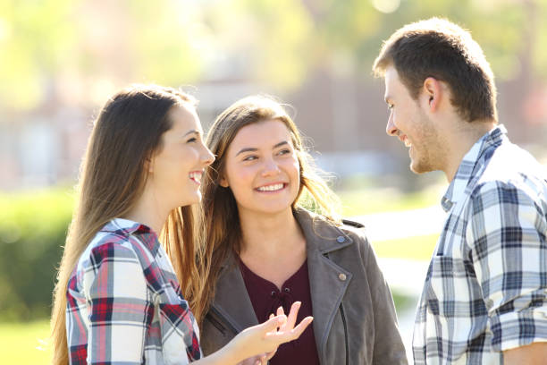 istock Three happy friends talking in the street 820498152