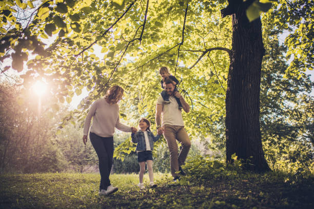 istock Happy family enjoying in spring walk in the forest. 820498880