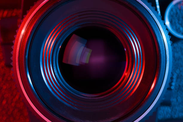 istock Close up of camera lens with red and blue lighting 820499556