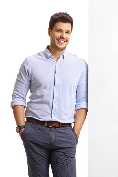 istock Elegant guy leaning against a wall and smiling 820499704