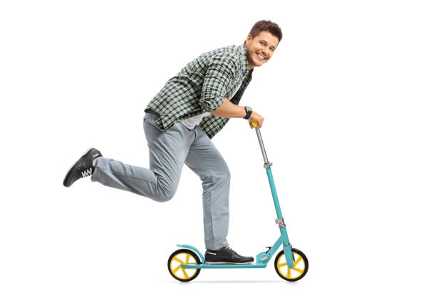 istock Young guy riding a scooter and looking at the camera 820503830
