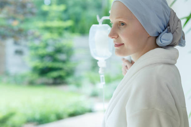 woman in robe smiling - chemotherapy drug imagens e fotografias de stock