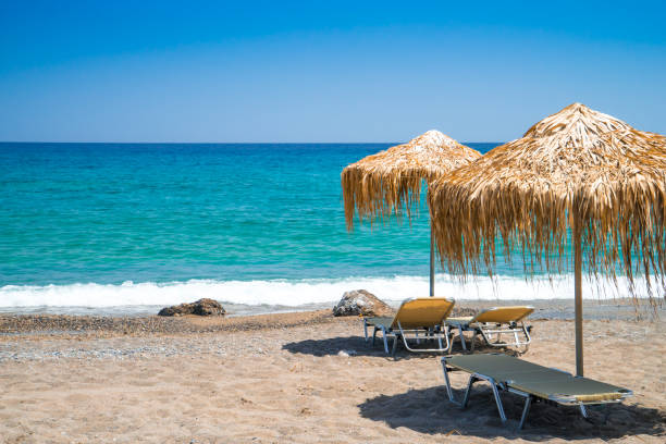istock Empty beach with straw umbrellas and sunbeds, Crete, Greece 820510922