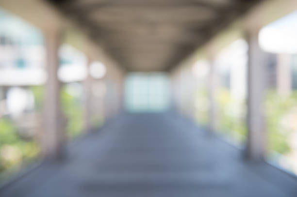 istock Blur background interior view looking out toward to empty office lobby and entrance doors and glass curtain wall 820514938