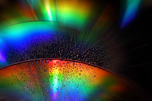 DVD and CD disc with water drops over. Full Colour Background.
