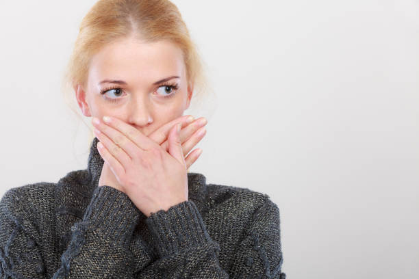 istock Shocked woman holding hand on lips 820520624