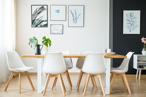 Bright spacious dining room with wooden big table