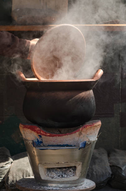 istock open baked clay kettle with hot water on traditional stove 820527444