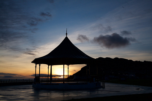 Silhouette of a gazebo on the waterfront in Bray, County Wicklow, Ireland at sunset.